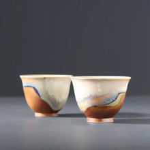Load image into Gallery viewer, Two ceramic Chinese gongfu tea cups with multicolored glaze on a gray background